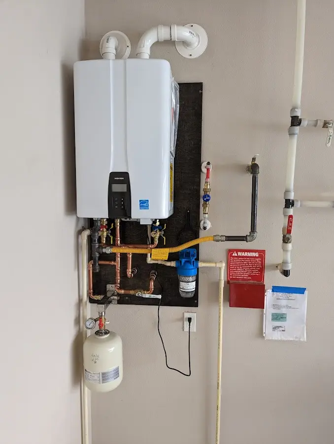 Professional plumber installing copper piping in a Fort Mill home